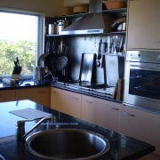 As the windows overlook a national park and countertop, cuisine classique, home appliance, kitchen, room, black