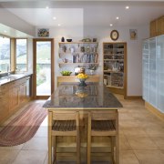 Dispaly shelves are placed above the cabinets next cabinetry, countertop, cuisine classique, flooring, interior design, kitchen, real estate, room, brown, gray