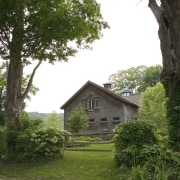 Exterior view of the house also showing the cottage, estate, farmhouse, grass, green, home, house, leaf, plant, property, real estate, rural area, sky, tree, white, brown