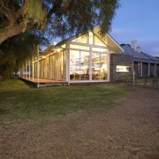 The lofty ceiling height in the extension is backyard, cottage, estate, facade, farmhouse, home, house, log cabin, property, real estate, shed, siding, yard, brown