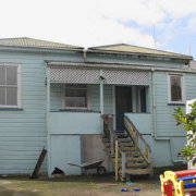 Before renovation, the west-facing rear of the hiuse cottage, facade, home, house, property, real estate, residential area, roof, siding, window, gray