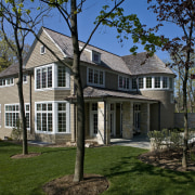 Exterior view of house featuring asymmetrical gabled roof building, cottage, estate, facade, farmhouse, historic house, home, house, mansion, neighbourhood, outdoor structure, property, real estate, residential area, siding, suburb, tree, brown