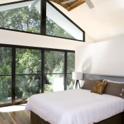 Windows that are almost floor-to-ceiling give the impression architecture, bed, bed frame, bedroom, ceiling, daylighting, estate, floor, hardwood, home, house, interior design, mattress, real estate, room, window, wood, white, brown