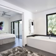 The downstairs bath enjoys an intimate view of bedroom, ceiling, estate, interior design, property, real estate, room, window, gray