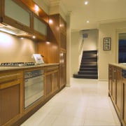 Timber cabinetry brings visual warmth to the open-plan cabinetry, countertop, cuisine classique, home, interior design, kitchen, real estate, room, wood, brown, orange