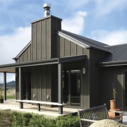 The residence sits low on its site, with facade, home, house, real estate, roof, siding, black