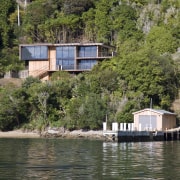 Exterior view of house and original boat shed cottage, home, house, lake, plant, property, real estate, reflection, reservoir, river, tree, water, waterway, brown