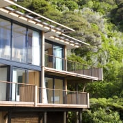 Exterior view of home with stepped facade, roofing, architecture, cottage, elevation, facade, home, house, plant, property, real estate, residential area, tree, brown