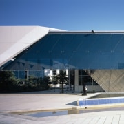 To reduce glare, university buildings are set among architecture, building, corporate headquarters, daylighting, daytime, facade, headquarters, sky, structure, gray, blue