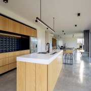 Wood cabinetry finishes and a polished concrete floor gray
