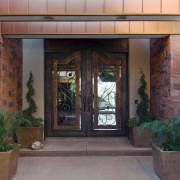 The textured red sandstone on the exterior walls courtyard, door, estate, facade, hacienda, home, property, real estate, window, black, gray