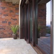 The sliding pocket doors in the great room, architecture, brick, door, floor, flooring, hardwood, home, interior design, laminate flooring, real estate, tile, wall, window, wood, wood flooring, wood stain, gray, black