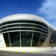 Ovoid forms and futuristic styling define the exhibition architecture, building, commercial building, convention center, corporate headquarters, daytime, facade, headquarters, metropolis, metropolitan area, sky, structure, teal