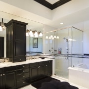 This bathroom features dark-stained wood cabinetry, which enhances bathroom, ceiling, home, interior design, room, white, black