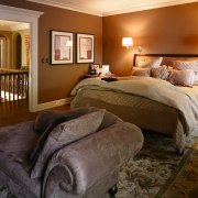 Warm earthy tones in the bedrooms lend a bed frame, bedroom, ceiling, estate, home, interior design, real estate, room, suite, wall, brown