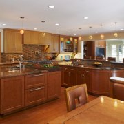 The simply styled cabinet doors have maple framing, cabinetry, countertop, cuisine classique, flooring, hardwood, home, interior design, kitchen, real estate, room, wood, wood flooring, brown