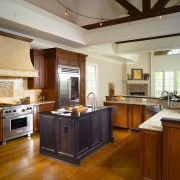 Different wood and granite types visually draw the cabinetry, ceiling, countertop, cuisine classique, estate, flooring, hardwood, interior design, kitchen, real estate, room, brown, gray