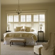 View of master bedroom which features painted shutters, bed frame, bedroom, ceiling, curtain, estate, floor, furniture, home, interior design, living room, room, wall, window, window blind, window covering, window treatment, wood, brown, gray