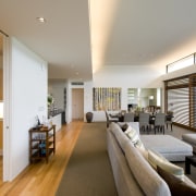 Ceiling heights are raised in the living area, architecture, ceiling, daylighting, floor, flooring, house, interior design, living room, real estate, room, window, gray, brown