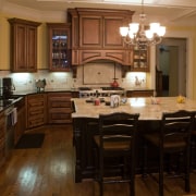 Image of a kitchen with a traditional design cabinetry, countertop, cuisine classique, dining room, floor, flooring, hardwood, interior design, kitchen, room, wood, wood flooring, brown