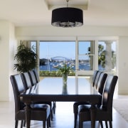 View of the dining area which features large chair, dining room, furniture, home, interior design, room, table, gray