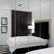 The master bedroom features a mirrored closet, lighting, bed, bed frame, bedroom, ceiling, furniture, interior design, light fixture, lighting, product design, gray, white