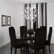 Dining room with chandelier, curtains, artwork, dining furnishings, chair, chandelier, dining room, furniture, interior design, light fixture, lighting, room, table, gray, black