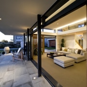 In the distance, beyond the ornamental pot, is architecture, estate, home, house, interior design, living room, penthouse apartment, real estate, brown