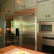 By the wine bar is a wine cooler. cabinetry, countertop, home appliance, interior design, kitchen, kitchen appliance, major appliance, room, brown