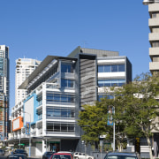 Image of the Centenary Square offices in Brisbane apartment, architecture, building, car, city, commercial building, condominium, corporate headquarters, daytime, downtown, facade, family car, house, luxury vehicle, metropolis, metropolitan area, mid size car, mixed use, motor vehicle, neighbourhood, real estate, residential area, sedan, sky, tower block, urban area, vehicle, blue