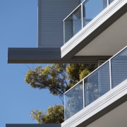 Exterior view of the Evolve apartment buildings which architecture, building, daylighting, elevation, facade, home, house, residential area, siding, sky, window, teal