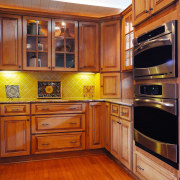 Image of a kitchen and features cabinetry from cabinetry, countertop, cuisine classique, floor, flooring, furniture, hardwood, interior design, kitchen, room, under cabinet lighting, wood, wood flooring, wood stain, brown