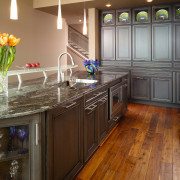 This kitchen by Cornerstone Design was awarded the cabinetry, countertop, cuisine classique, floor, flooring, hardwood, interior design, kitchen, laminate flooring, room, wood, wood flooring, wood stain, brown