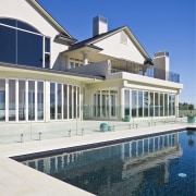 Nebulite Auckland supplied all the custom-designed powdercoated aluminium architecture, building, estate, facade, home, house, mansion, property, real estate, residential area, swimming pool, villa, water, white, blue