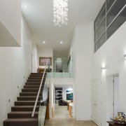 Town &amp; Country Residential oversees all elements of architecture, ceiling, daylighting, floor, flooring, handrail, home, house, interior design, lobby, real estate, stairs, gray