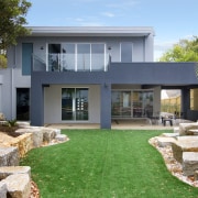 A passive enviromental design by Englehart Homes ensures architecture, backyard, elevation, estate, facade, grass, home, house, lawn, property, real estate, residential area, villa, window, yard