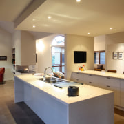 Long butt-jointed glazed windows frame views across the countertop, interior design, kitchen, real estate, room, brown, orange