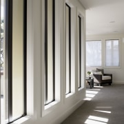 Tall windows overlook the hall to the master door, floor, flooring, home, interior design, real estate, window, window covering, gray, white