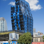 Four shades of blue glass were used to architecture, building, city, cityscape, commercial building, condominium, corporate headquarters, daytime, downtown, facade, landmark, metropolis, metropolitan area, mixed use, neighbourhood, real estate, reflection, residential area, sky, skyscraper, tower, tower block, urban area, blue