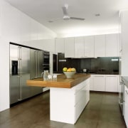 view of kitchen area which features a kitchen cabinetry, countertop, cuisine classique, interior design, kitchen, real estate, room, white