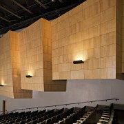 View of the auditorium which has more subdued architecture, auditorium, building, ceiling, concert hall, daylighting, interior design, light, lighting, opera house, performing arts center, theatre, wall, wood, orange