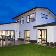 The show home, in Harbourside Drive, Karaka, features cottage, elevation, estate, facade, farmhouse, home, house, property, real estate, residential area, roof, siding, villa, window, blue