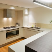The kitchen is located on the lower floor, countertop, floor, interior design, kitchen, property, real estate, room, gray