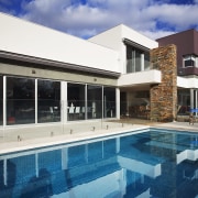 Created by Stovehaven Homes, this house is designed architecture, estate, home, house, property, real estate, swimming pool, villa, window