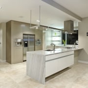 The kitchen, manufactured by Fyfe kitchens, is equipped cabinetry, countertop, floor, flooring, interior design, kitchen, laminate flooring, real estate, room, tile, wood flooring, gray