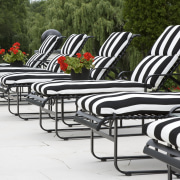 Image of the exterior of this home which chair, furniture, outdoor furniture, outdoor structure, patio, product design, sunlounger, table, white, brown