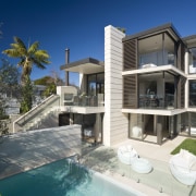 Exterior view of house which features pool, cladding, apartment, architecture, elevation, estate, facade, family car, home, house, property, real estate, residential area, swimming pool, villa