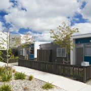 This Housing New Zealand Devlopment features modular homes, architecture, corporate headquarters, elevation, facade, home, house, neighbourhood, property, real estate, residential area, gray