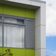 This Housing New Zealand Devlopment features modular homes, architecture, building, facade, house, yellow, gray, white