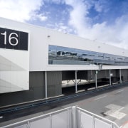 Images of the international terminal at Auckland Airport. airport terminal, architecture, building, corporate headquarters, facade, infrastructure, metropolitan area, public transport, sky, structure, transport, white